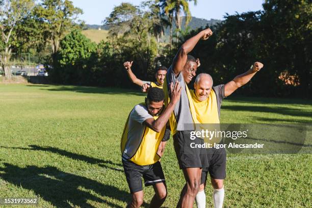 yellow soccer team celebrating a goal - scoring a goal soccer stock pictures, royalty-free photos & images