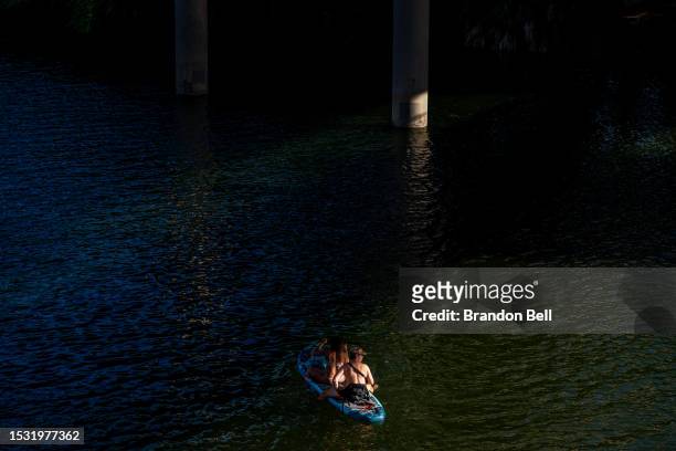 People paddle along the Colorado River on July 10, 2023 in Austin, Texas. Record-breaking temperatures continue soaring as prolonged heatwaves sweep...