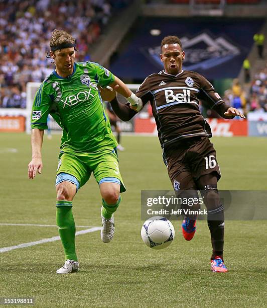 Jeff Parke of the Seattle Sounders FC and Matt Watson of the Vancouver Whitecaps FC cause after lose ball during their MLS game September 29, 2012 at...