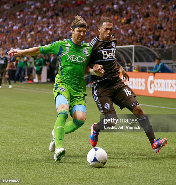 Jeff Parke of the Seattle Sounders FC and Matt Watson of the Vancouver Whitecaps FC cause after lose ball during their MLS game September 29, 2012 at...