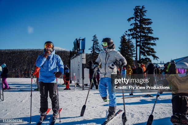 friends spending time together between ski runs on sunny winter day - disabled extreme sports stock pictures, royalty-free photos & images