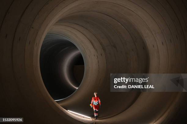 Civil engineer walks inside a 7 metre concrete tunnel at the Thames Tideway building site, in west London, on June 14, 2023. London's existing...