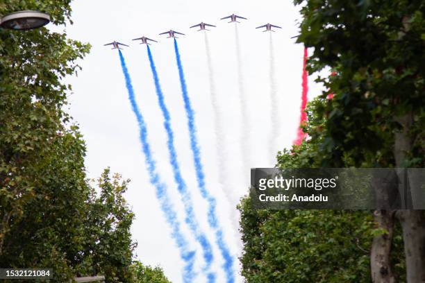 French Air Force elite acrobatic flying team "Patrouille de France" performs a fly-over during the Bastille Day military parade on the Champs-Elysees...