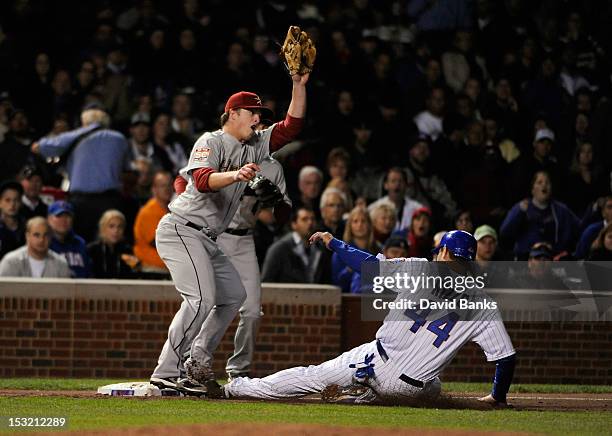 Anthony Rizzo of the Chicago Cubs slides safely into third base as Matt Dominguez of the Houston Astros takes the throw in the third inning on...