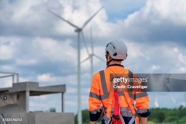 the expertise of dedicated technicians. this showcases the intricate maintenance work, risk prevention, and responsible energy production. join the movement towards a brighter, sustainable . - material reflector de seguridad fotografías e imágenes de stock