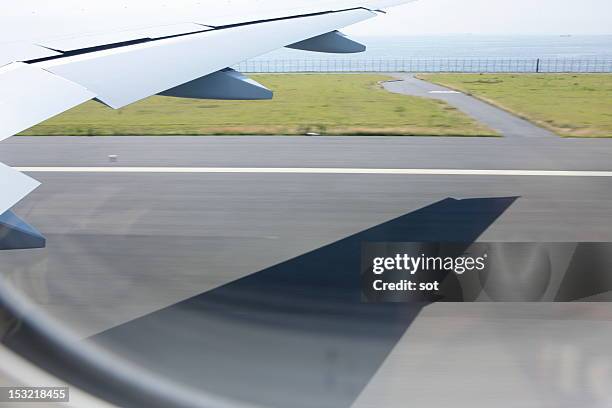 view out an airplane window just before take off - airplane shadow stock pictures, royalty-free photos & images