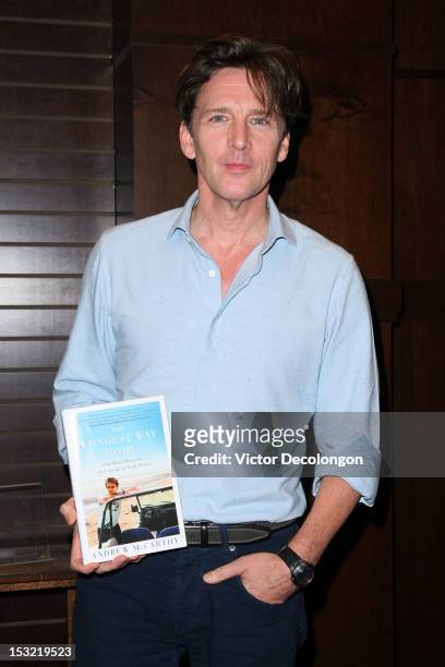 Andrew McCarthy holds a copy of his travel book "The Longest Way Home" at Barnes & Noble bookstore at The Grove on October 1, 2012 in Los Angeles,...