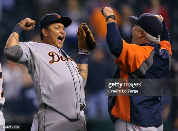 Miguel Cabrera of the Detroit Tigers and bullpen coach Mike Rojas celebrate after winning the American League Central title at Kauffman Stadium on...