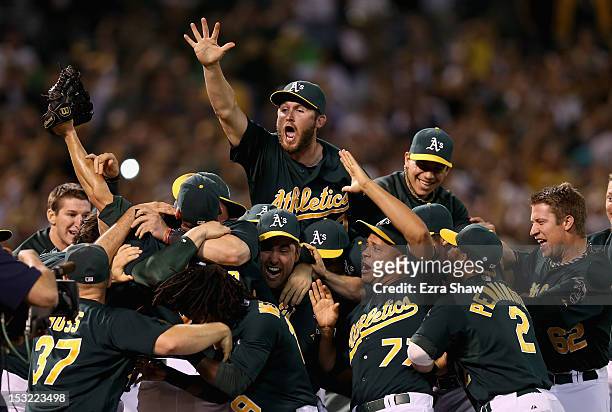 The Oakland Athletics celebrates after the Athletics beat the Texas Rangers to clinch a playoff spot at O.co Coliseum on October 1, 2012 in Oakland,...