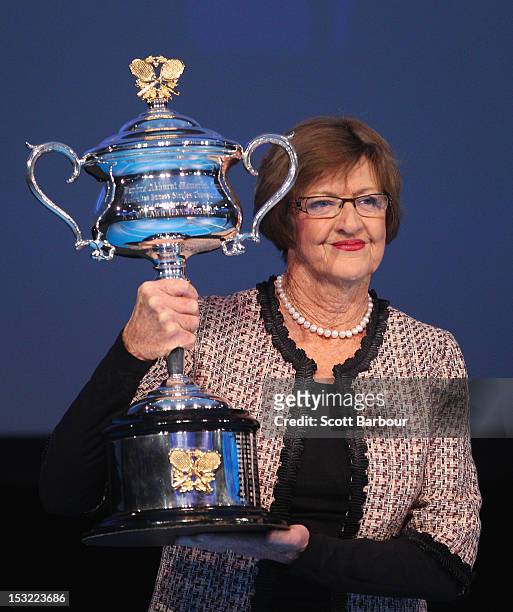 Former tennis player Margaret Court carries the Daphne Akhurst Trophy during the 2013 Australian Open launch at Melbourne Park on October 2, 2012 in...