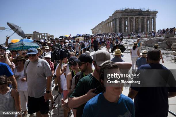 Tourists tour the Acropolis archaeological site, during extreme hot weather conditions, in Athens, Greece, on Friday, July 14, 2023. In Athens, the...