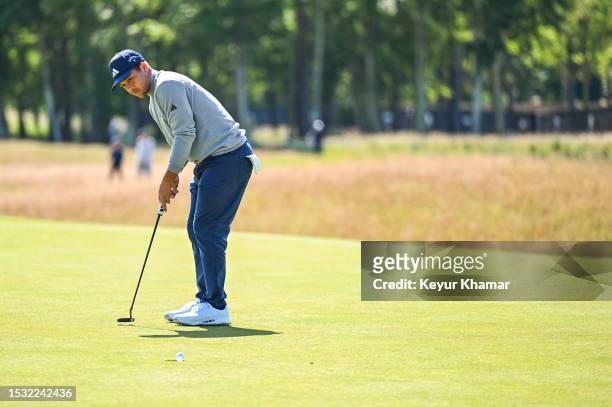 Xander Schauffele makes a putt on the second hole green during the first round of the Genesis Scottish Open at The Renaissance Club on July 13, 2023...