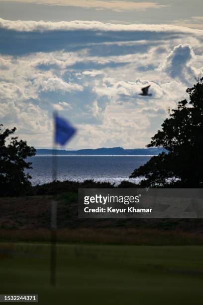 Scenic view of a pinflag as the sun hits the Firth of Forth behind during the first round of the Genesis Scottish Open at The Renaissance Club on...