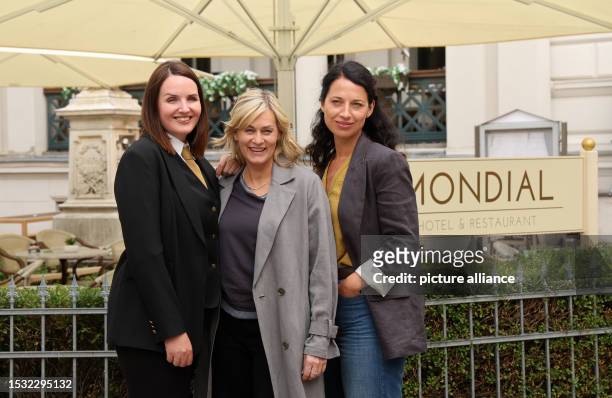 July 2023, Mecklenburg-Western Pomerania, Schwerin: Lea Sophie Salfeld , Gesine Cukrowski and Agnes Mann stand in front of the hotel during a photo...