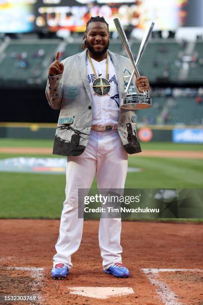 Vladimir Guerrero Jr. #27 of the Toronto Blue Jays poses for photos with his trophy after winning the T-Mobile Home Run Derby at T-Mobile Park on...