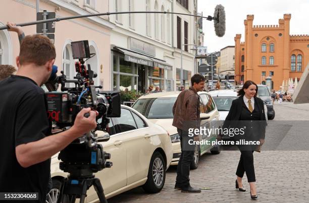 July 2023, Mecklenburg-Western Pomerania, Schwerin: During filming for "Hotel Mondial," a cameraman films a scene with Tobias van Dieken and Lea...