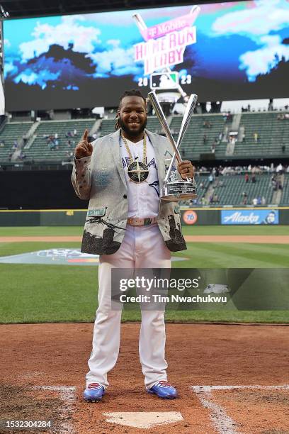 Vladimir Guerrero Jr. #27 of the Toronto Blue Jays poses for photos with his trophy after winning the T-Mobile Home Run Derby at T-Mobile Park on...