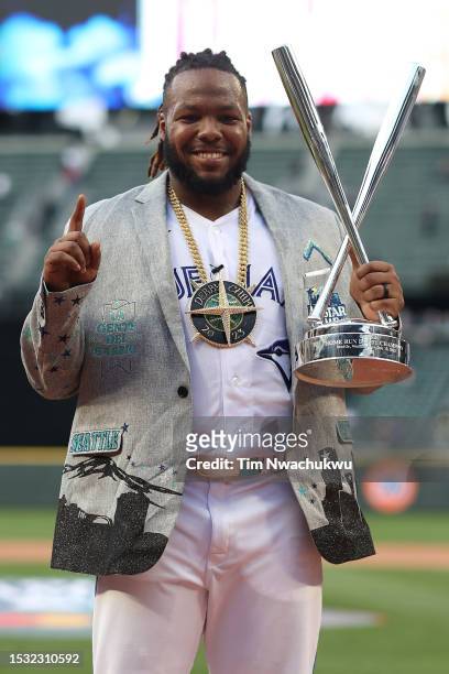 Vladimir Guerrero Jr. #27 of the Toronto Blue Jays poses for photos with his trophy after winning the T-Mobile Home Run Derby at T-Mobile Park on...