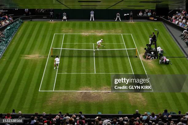 Italy's Jannik Sinner returns the ball to Serbia's Novak Djokovic during their men's singles semi-finals tennis match on the twelfth day of the 2023...