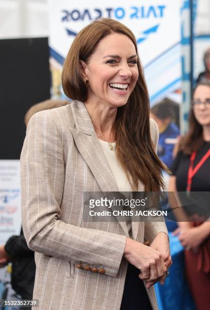 Britain's Catherine, Princess of Wales laughs as she shares a joke with Cadets at the Techno Zone, which aims to inspire young people into exploring...