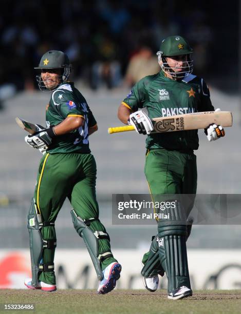 Kamran Akmal and Nasir Jamshed of Pakistan run between the wickets during the ICC World Twenty20 2012 Super Eights Group 2 match between Australia...