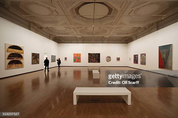 Members of the public admire the artworks on display in the 'RA Now' exhibition at the Royal Academy on October 2, 2012 in London, England. The RA...