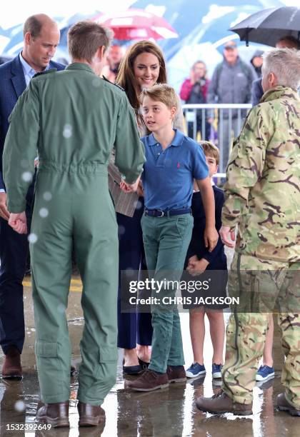 Britain's Prince George of Wales shakes hands as he arrives to visit to the Air Tattoo at RAF Fairford on July 14, 2023 in Fairford, central England.