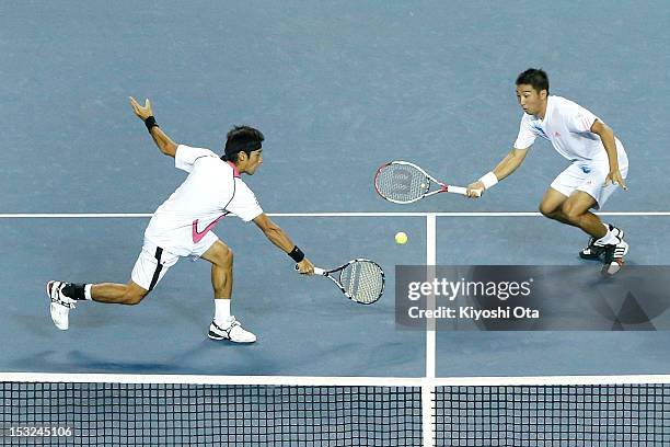 Yuichi Sugita and Yasutaka Uchiyama of Japan play in their first round doubles match against Daniele Bracciali of Italy and Frantisek Cermak of the...