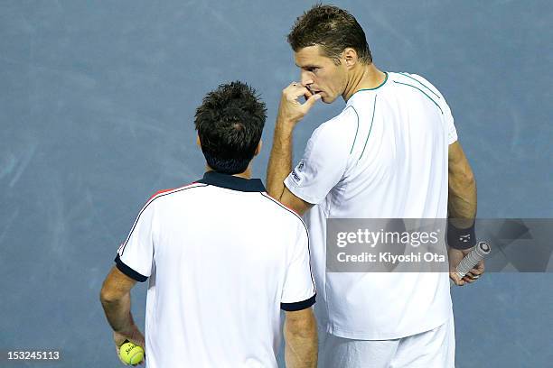 Frantisek Cermak of the Czech Republic speaks to his team-mate Daniele Bracciali of Italy as they play in their first round doubles match against...