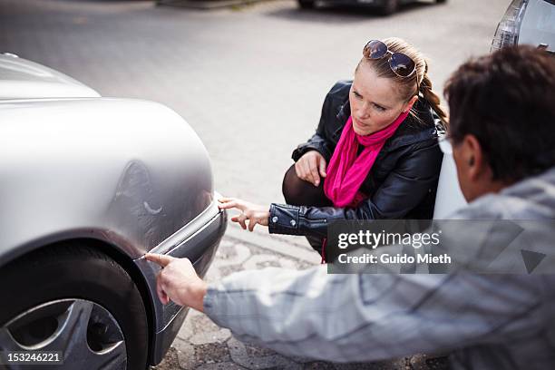 man and woman with car - car collision stock pictures, royalty-free photos & images