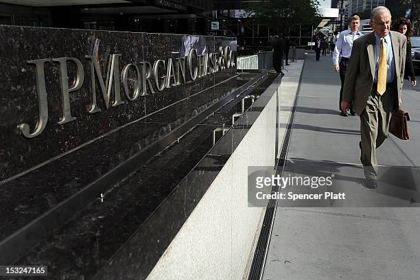 People pass a sign for JPMorgan Chase & Co. At it's headquarters in Manhattan on October 2, 2012 in New York City. New York Attorney General Eric...
