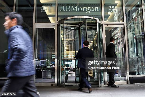 People pass a sign for JPMorgan Chase & Co. At it's headquarters in Manhattan on October 2, 2012 in New York City. New York Attorney General Eric...