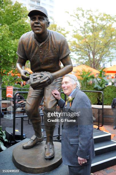 Former Oriole Brooks Robinson stands with his statue during a ceremony before the game between the Baltimore Orioles and the Boston Red Sox at Oriole...