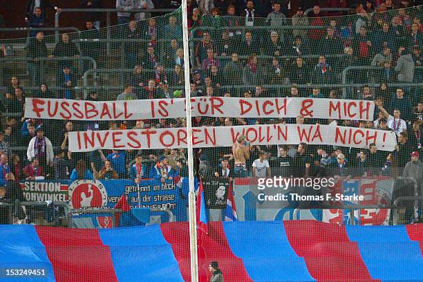 Ultras of Wuppertal show a banner against investors taking over football clubs during the Regionalliga West match between Wuppertaler SV Borussia and...