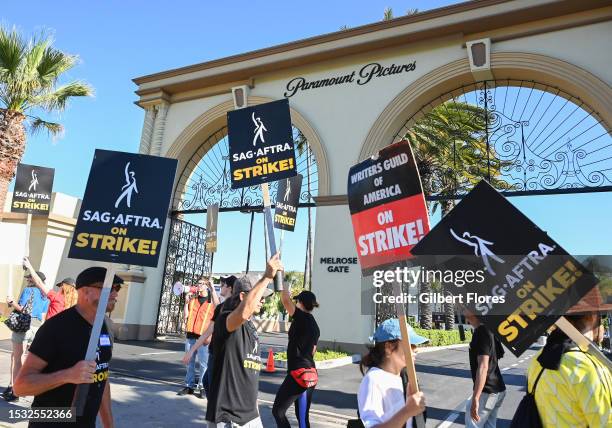 And WGA Members and Supporters walks the picket line in support of the SAG-AFTRA and WGA strike on Day 2 at the Paramount Pictures Studio on July 14,...
