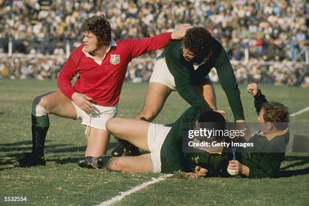 Fran Cotton of the British Lions hands off his opponent during the British Lions, tour match against South Africa. In South Africa. Mandatory Credit:...