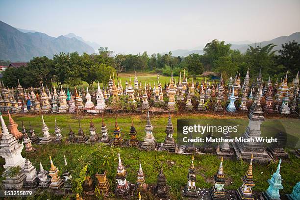 aerial views over a graveyard in a city. - vang vieng balloon stockfoto's en -beelden