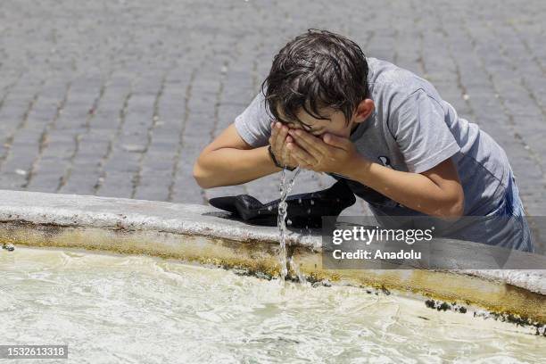 Child refreshes at a fountain in Piazza del Popolo, Rome, Italy, on July 14, 2023. A heatwave could break records in Italy, with temperatures...