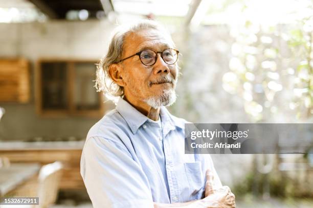 portrait of smiling face of senior man - daily life in indonesia stock pictures, royalty-free photos & images