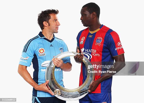 Alessandro Del Piero of Sydney FC and Emile Heskey of Newcastle Jets hold the A-League Trophy during a 2012/13 A-League player portrait session at...