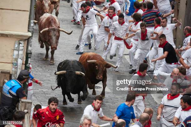 Runners next to the bulls during the fifth running of the bulls of the San Fermin 2023 fiestas, on July 11 in Pamplona, Navarra, Spain. The fifth...