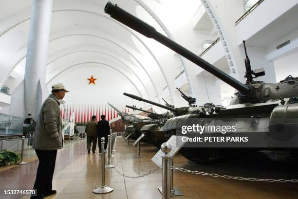 Visitor looks at old Chinese built tanks on display at the Chinese Military Museum in Beijing, 04 November 2002. China has made huge strides in...