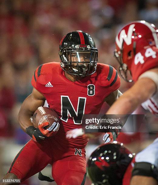 Running back Ameer Abdullah of the Nebraska Cornhuskers runs through the Wisconsin Badgers during their game at Memorial Stadium on September 29,...