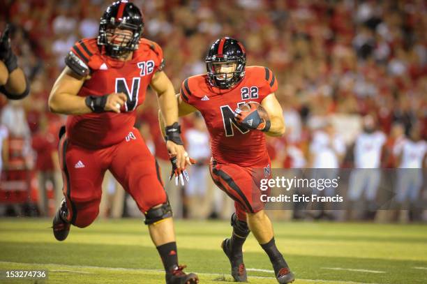 Running back Rex Burkhead of the Nebraska Cornhuskers follows teammate offensive linesman Justin Jackson of the Nebraska Cornhuskers during their...