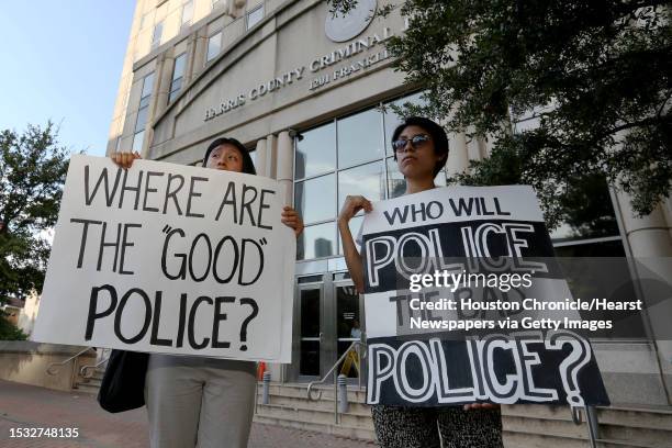 Sisters Karina Rivera, left, and Mayra Rivera bring signs to participate the protest outside of Harris County 180th Criminal Court after a grand-jury...