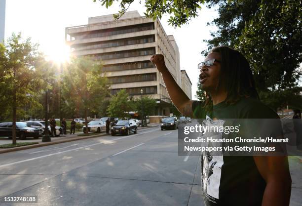 Gregory Chatman shouts across the street to the police officers while protesting outside of Harris County 180th Criminal Court after a grand-jury...