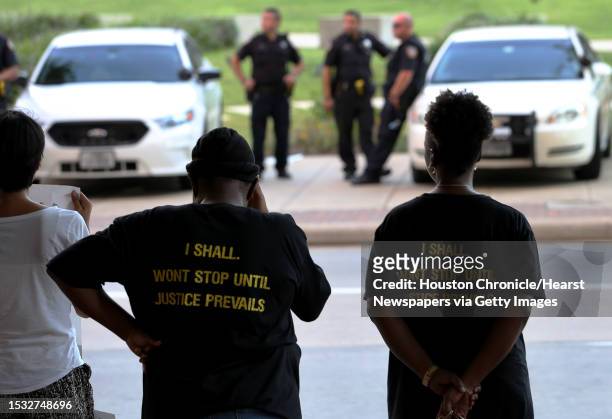 About a dozen of protesters face police outside of Harris County 180th Criminal Court after a grand-jury no-billed a Precinct 5 deputy who shot and...