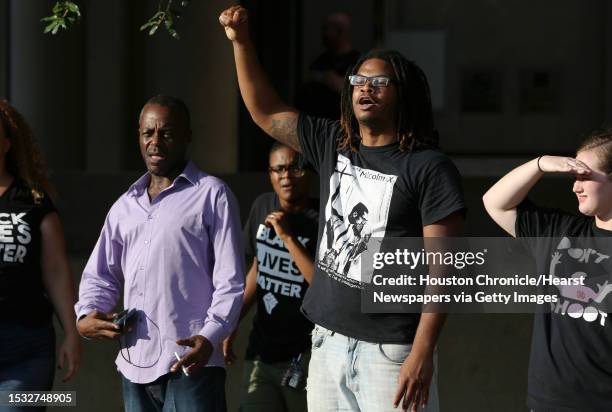 About a dozen of protesters face police outside of Harris County 180th Criminal Court after a grand-jury no-billed a Precinct 5 deputy who shot and...