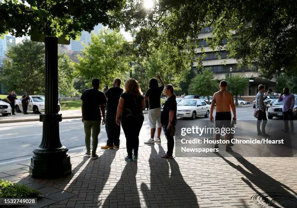 About a dozen of protesters face police outside of Harris County 180th Criminal Court after a grand-jury no-billed a Precinct 5 deputy who shot and...