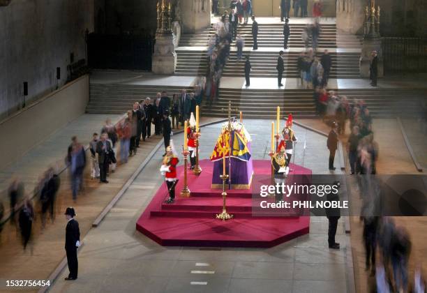 Mourners queue to file past the coffin of Queen Elizabeth, the Queen Mother, in Westminster Hall 05 April 2002, where she will lie-in-state until her...